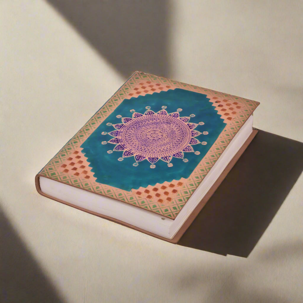 Decorative notebook with a mandala design on a white background