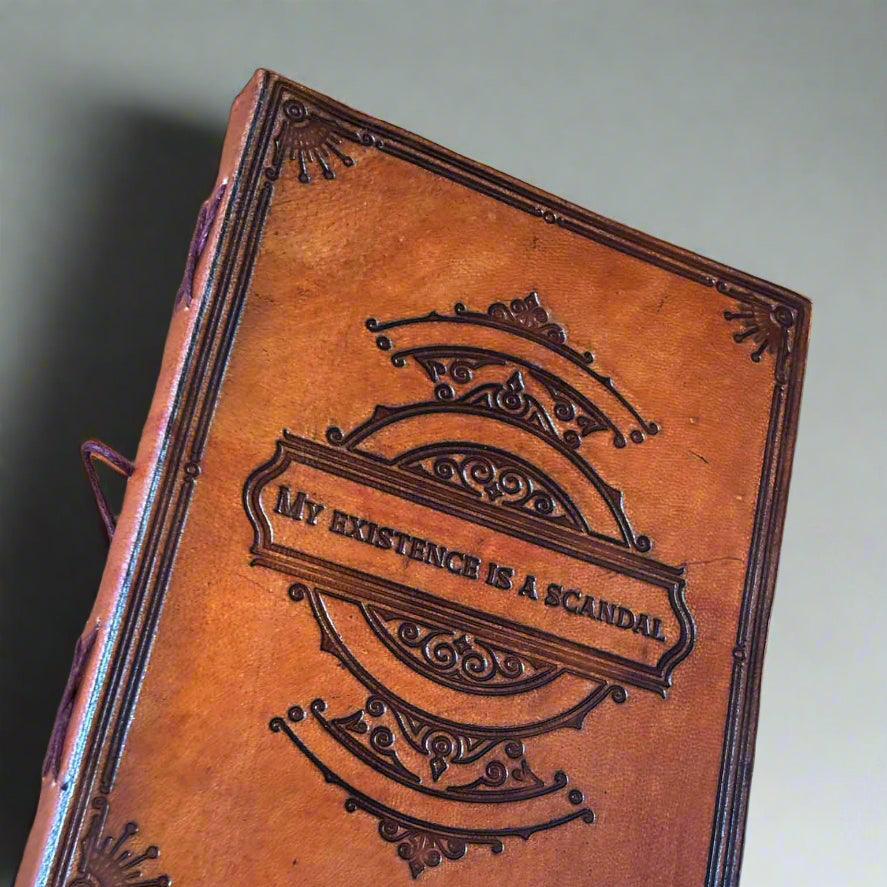 Leather-bound book with embossed design and text on a brown background