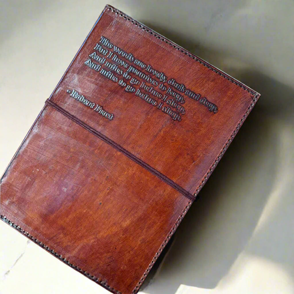 Brown leather-bound book with embossed text on a brown background