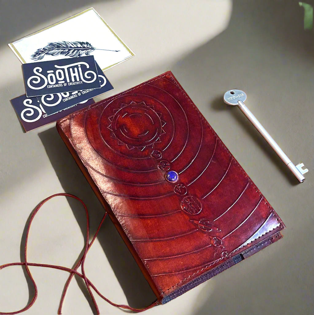 Space-themed leather notebook – embossed with galactic elements and adorned with a blue cobalt stone