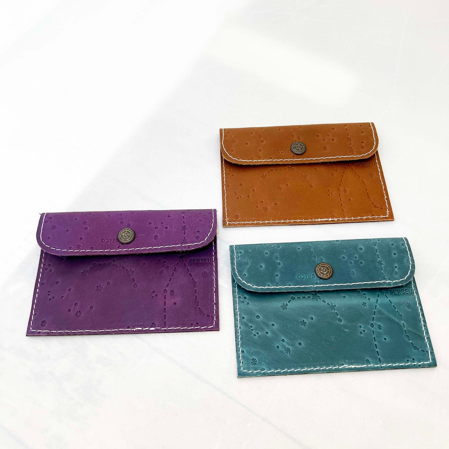 Leather envelope wallet with celestial constellation pattern – available in teal, purple, and brown for a dreamy, star-kissed touch of elegance
