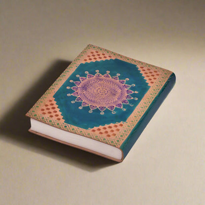Decorative notebook with mandala design on a white background