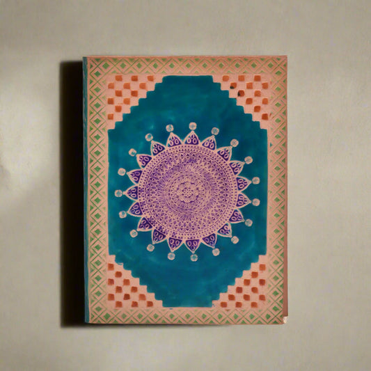 Decorative notebook with mandala design on a white background