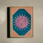 Decorative notebook with mandala design on a white background