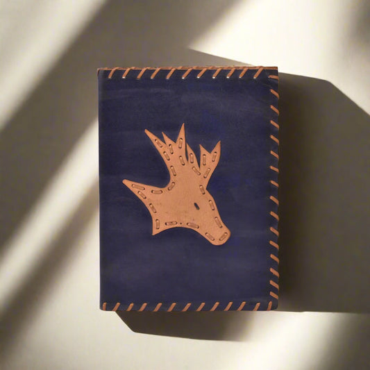 Navy blue leather pouch with brown deer head design on a white background