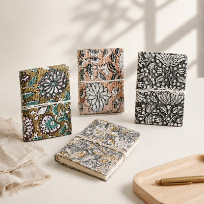 Signature twin artisan hardcover notebook journals on a curated desktop next to a pen cup.