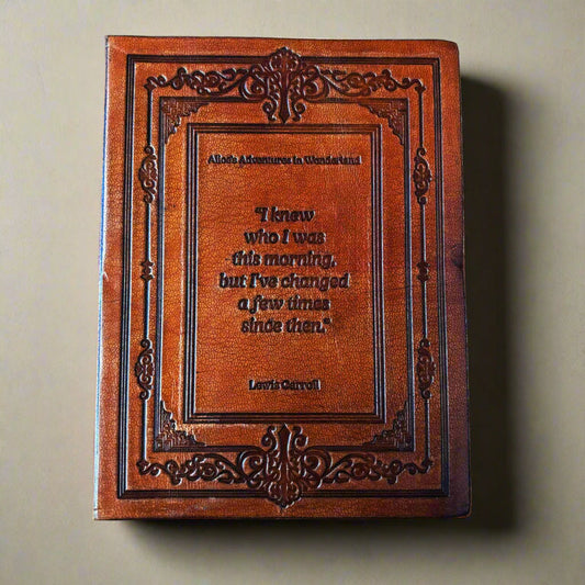Decorative leather-bound book with a quote on a beige background