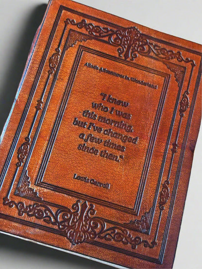 Brown leather-bound book with embossed text on a beige background