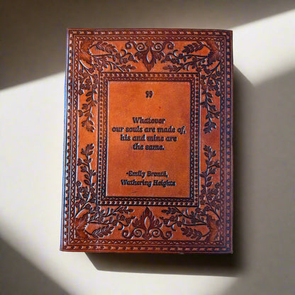 Decorative leather book with embossed text on a beige background