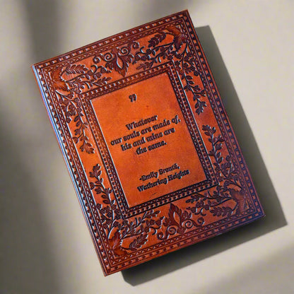 Decorative leather book with embossed text on a beige background