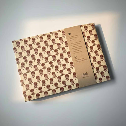 Patterned brown envelope with a visible brand logo on a light gray background