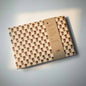 Patterned brown envelope with a visible brand logo on a light gray background