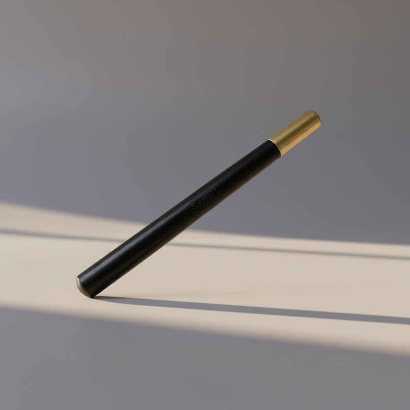 Black pen with gold cap on a white background