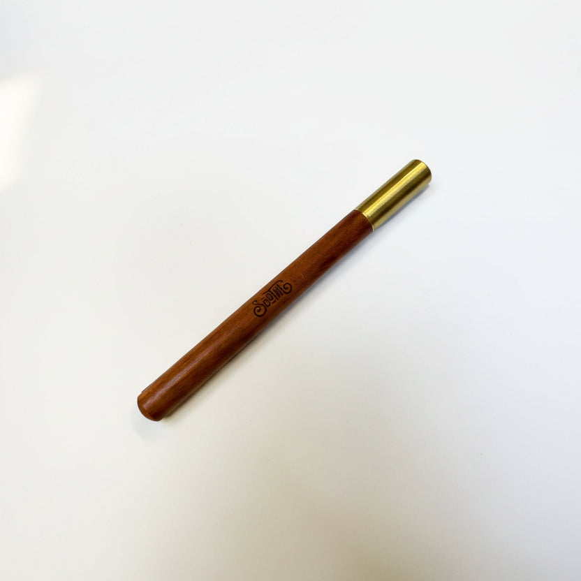 Wooden pen with gold cap on a white background