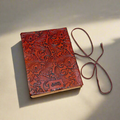 Stunning red leather notebook with embossed floral designs and a quote from Wuthering Heights by Emily Bronté printed on the cover - meaningful gift for literature enthusiasts, newlyweds, anniversaries, or anyone who believes in the powerful connection of soul