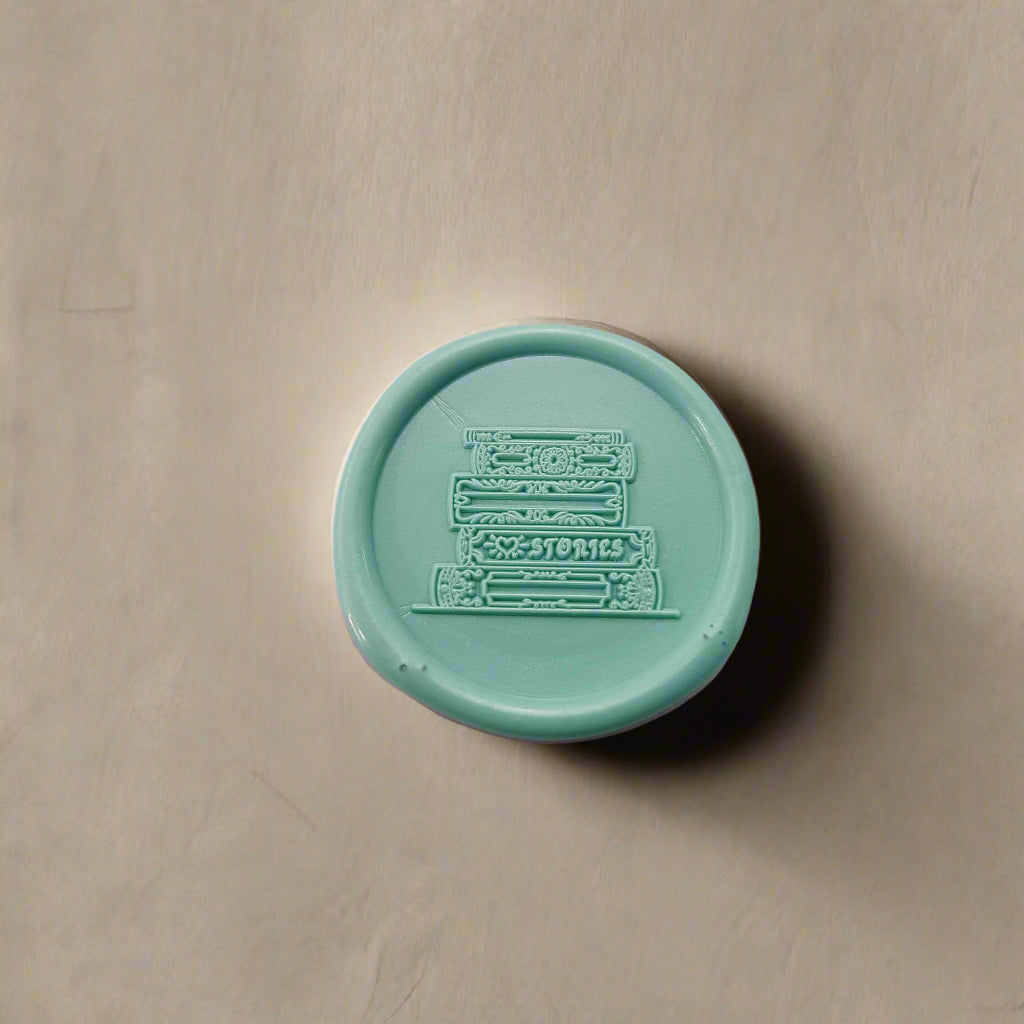 Gold-toned wax seal with stacks of books engraving – classic detail for modern creatives, old-soul writers, and bookworms