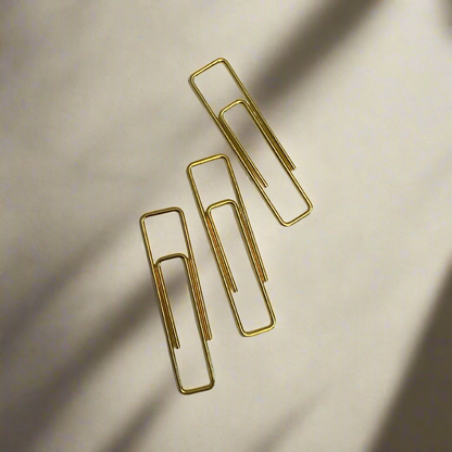 Stylish gold paper clips in unique geometric shapes – modern, functional, and perfect for adding flair to your workspace