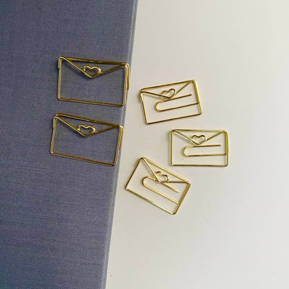 Stylish gold paper clips in unique geometric shapes – modern, functional, and perfect for adding flair to your workspace